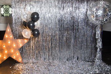 Foil balloons on the background against a shiny wall.