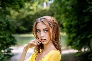 Portrait of a charming young girl in nature. Long hair and beautiful eyes.