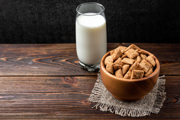 Breakfast dried chocolate pads on dark wooden background. 