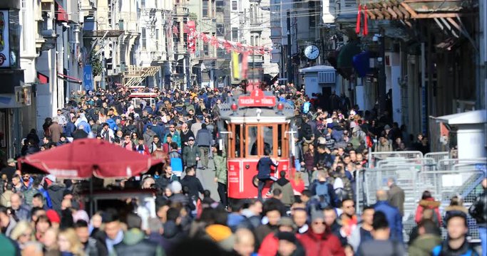 ISTANBUL, TURKEY- JANUARY 7, 2019 :  A view of crowded walking on famous Taksim Istiklal Avenue at winter time