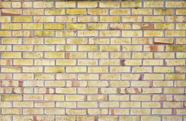 Texture of a yellow brick wall background in the countryside. Brick masonry horizontal color technology architecture wallpaper.