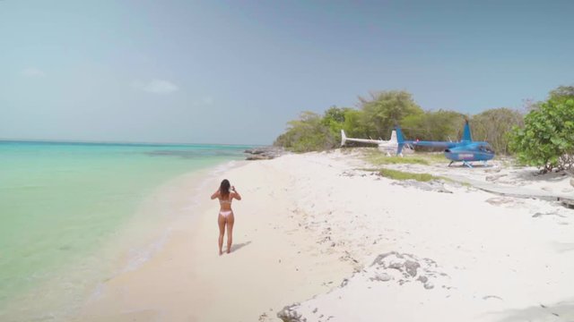 Bikini-Clad Woman on Tropical Beach Near Helicopters in Bayahibe, Dominican Republic