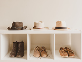 Men's leather boots and shoes on shelf with matching hats - vintage matte filter ettect