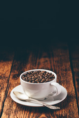 Roasted coffee beans in white cup