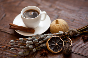Coffee cup and willow branches, dry lemon, cinnamon.