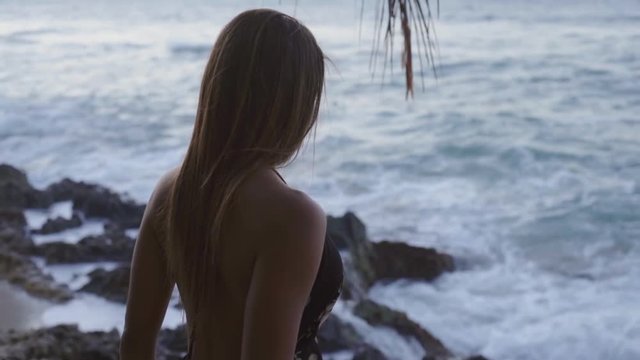 Woman's Bare Shoulders Nearby and Waves Crashing on Shore in Cabarete, Dominican Republic