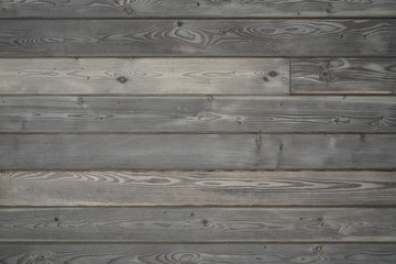 Fototapeta na wymiar Flat gray brown wood surface with aged boards lined up. Wood paneling with grain and texture. 