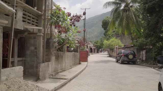 A Pan Down of Tropical Street with Green Hills in Background in Citadel Laferriere, Haiti
