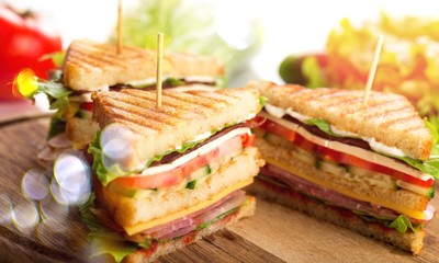Fresh tasty sandwiches on wooden background