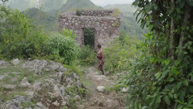 An Exotic Woman Stands Near an Ancient Building in Citadel Laferriere, Haiti