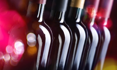 Closeup of dark wine bottles in row - Powered by Adobe