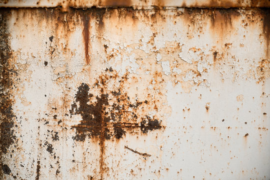Rusty metal textured background with chipped white paint. Old rough rusted grungy surface
