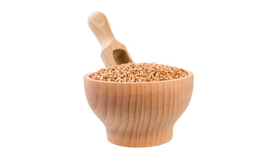roasted buckwheat in wooden bowl and scoop isolated on white background. nutrition. bio. natural food ingredient.front view.