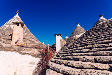 Fototapeta na wymiar Roofs with symbols in the trulli, in the famous Italian city of Alberobello.
