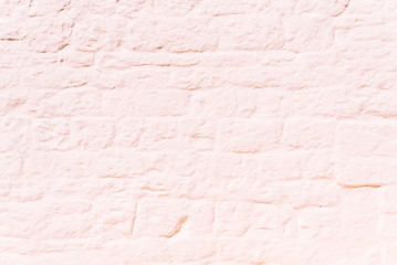 stone wall painted completely white, in the sun, ideal to use as a background for its smooth texture.