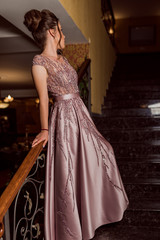 Young beautiful girl in pink luxury dress for the prom night