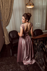 Young beautiful girl in pink luxury dress for the prom night