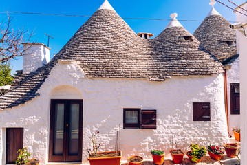Houses of the tourist and famous Italian city of Alberobello, with its typical white walls and...