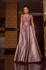Young beautiful girl in pink luxury dress for the prom night