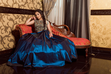 Fototapeta premium Beautiful young lady in luxury blue dress for her prom night