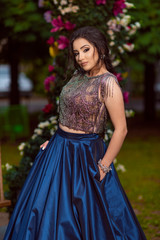 Fototapeta premium Beautiful young lady in luxury blue dress for her prom night