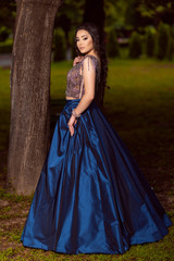 Fototapeta premium Beautiful young lady in luxury blue dress for her prom night