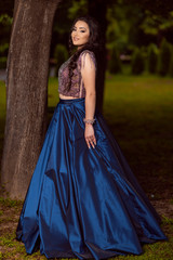 Beautiful young lady in luxury blue dress for her prom night