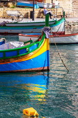 Fototapeta na wymiar A Luzzu boat bow - the traditional Maltese fishing boat at Spinola Bay in St. Julian's, Malta