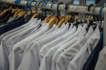 White medical robes on hangers, close up