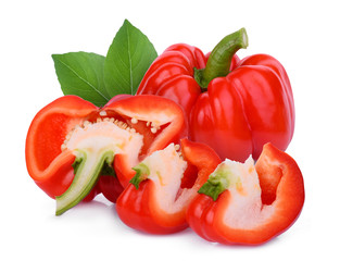 whole and half red bell pepper with green leaf isolated on white background