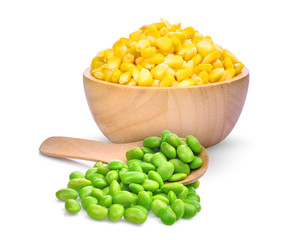 sweet corn in wooden bowl and edamame beans in wooden spoon isolated on white background