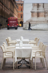 Table's restaurant in an empty piazza maggiore,Bologna,italy