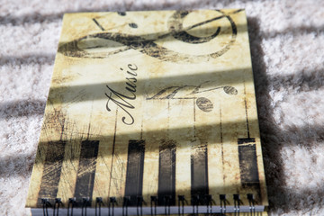 Musical note book on white carpet background - Image