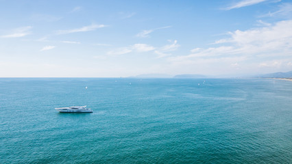 Yacht at the sea in Europe. Aerial view of luxury floating ship at sunset. Colorful landscape with boat in marina bay, blue sea. Top view from drone of yacht. Luxury cruise. Seascape with motorboat