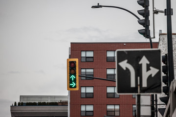 Traffic light abiding by American standards indicating two directions with green light, at a...