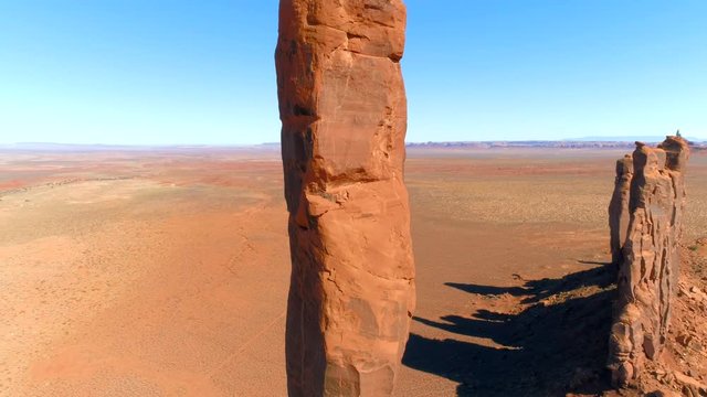 MONUMENT VALLEY, ARIZONA, USA. Stuning red-sand desert of Monument Valley Navajo Tribal Park. Iconic panorama of red sandstone canyons and dramatic rock monuments towering above the valley floor.