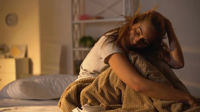 Depressed woman falling asleep in bed, hangover weakness, melancholy, laziness
