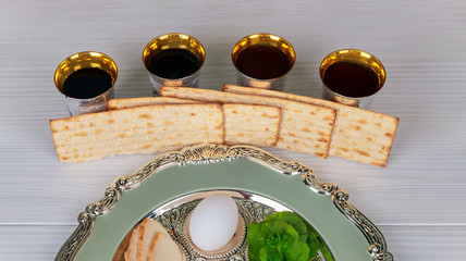 Red kosher wine four glasses of matzah or matza Passover Haggadah