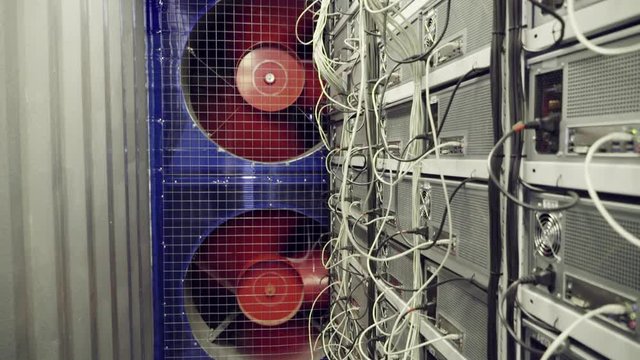 Special servers room for farms of mining cryptocurrency working process with huge rotating coolers which are cooling the equipment.
