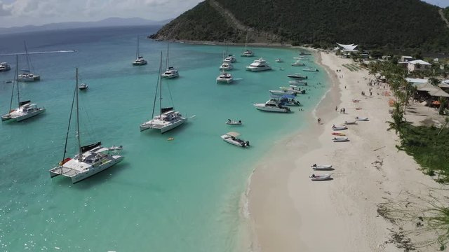 Aerial Forward: Plenty of Small Boats near the Shores of Jost Van Dyke Beach in Jost Van Dyke, British Virgin Islands