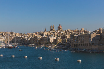Fototapeta na wymiar City of Senglea, Malta under blue sky, with Knisja Maria Bambina