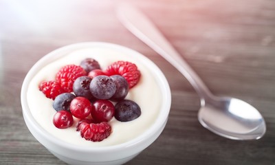 Yogurt with forest berries  on wooden table