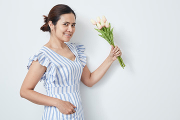 Beautiful woman holding bouquet of tulips