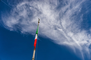 ROME, ITALY - 11 SEPTEMBER 2018: Italian flag against the blue sky, Vittoriano