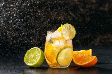 Fototapeta na wymiar Cocktail with orange, lime and ice