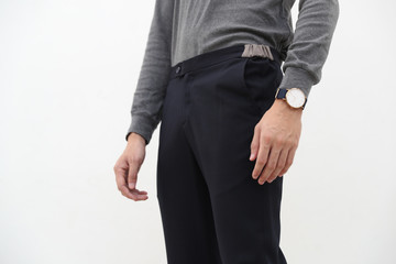 close-up of A handsome man in gray turtleneck shirt and black long trousers on white background.