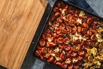 Baked juicy cherry tomatoes baking tray copy space top view