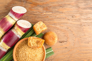Brown sugar and cane on the table top view