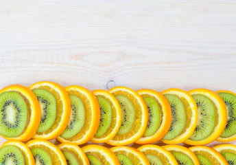 Border for design with kiwi and orange on wooden background. Empty space for text