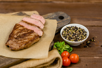 Fresh grilled meat. Grilled beef steak medium rare on wooden cutting board